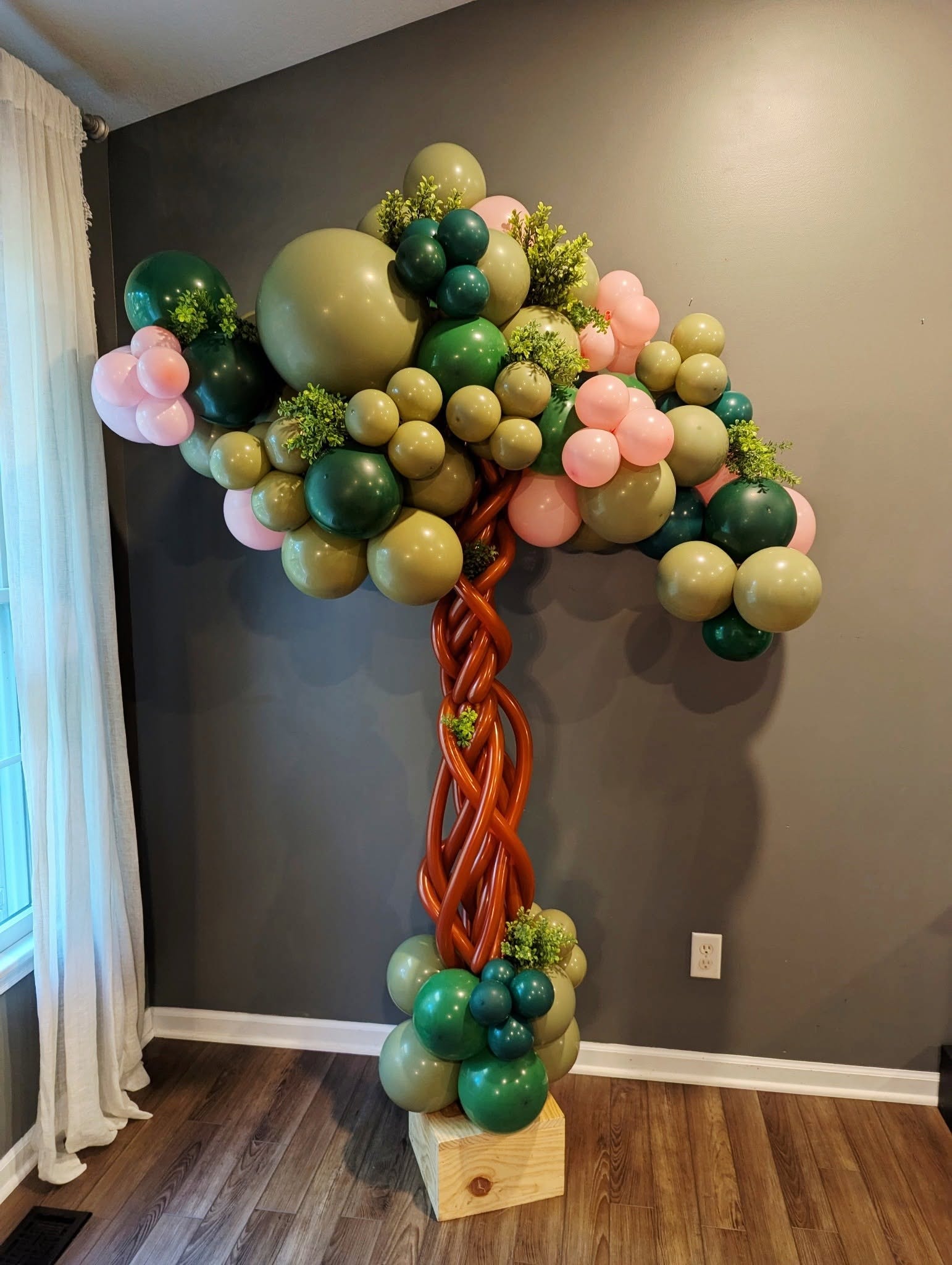 Decorative balloon tree with greenery indoors