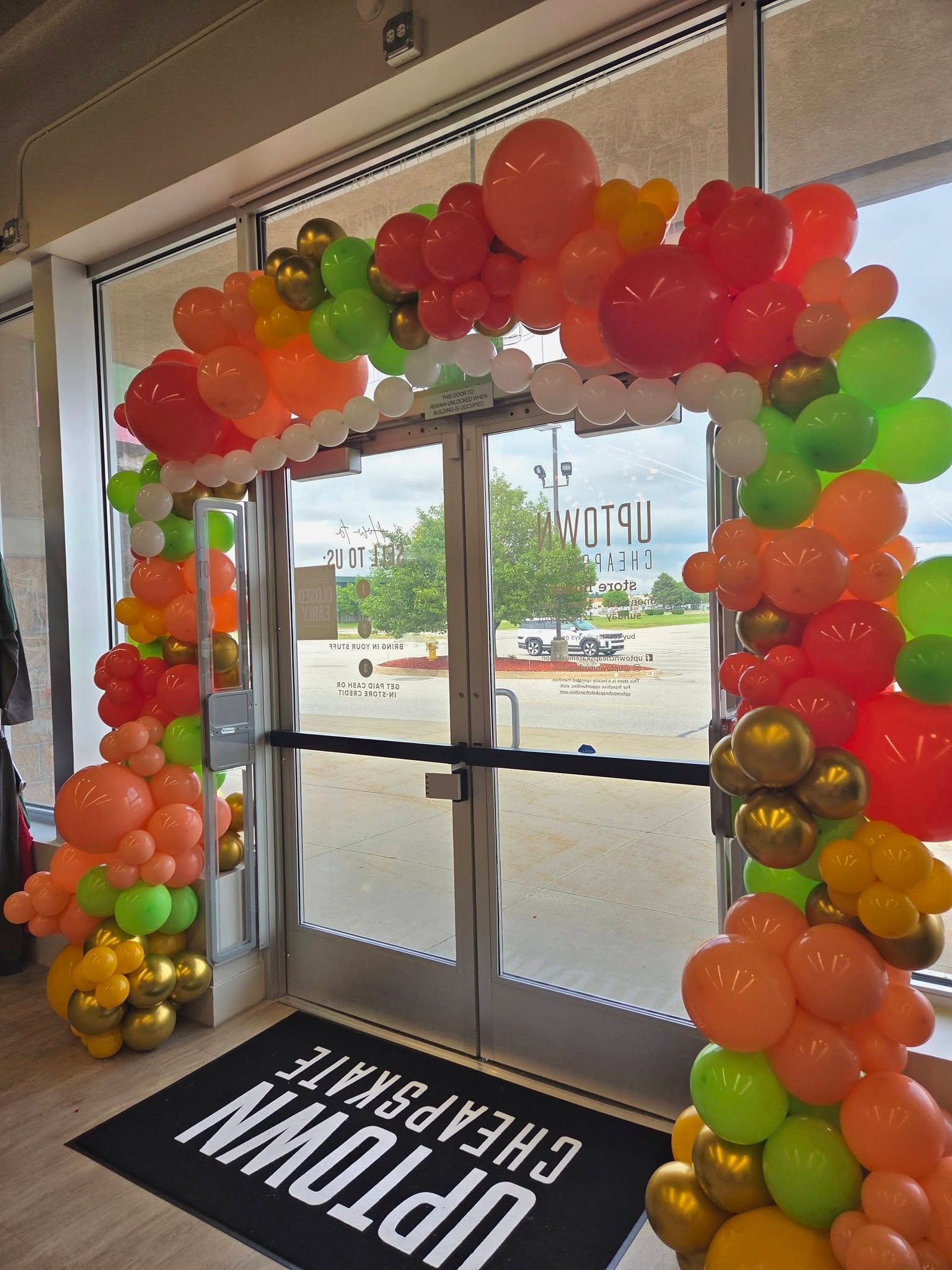 Colorful balloon arch at Uptown Cheapskate store entrance
