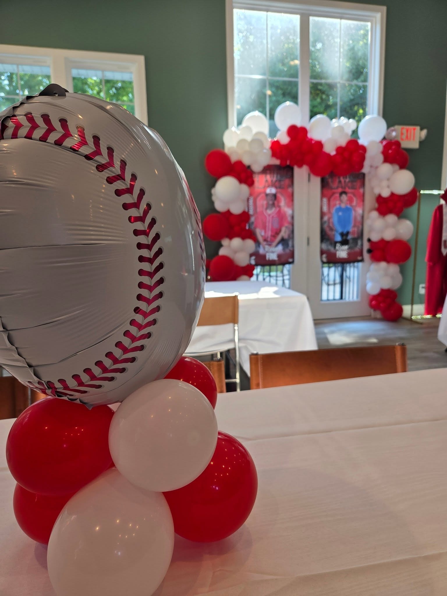 Baseball themed red and white balloon centerpiece and arch
