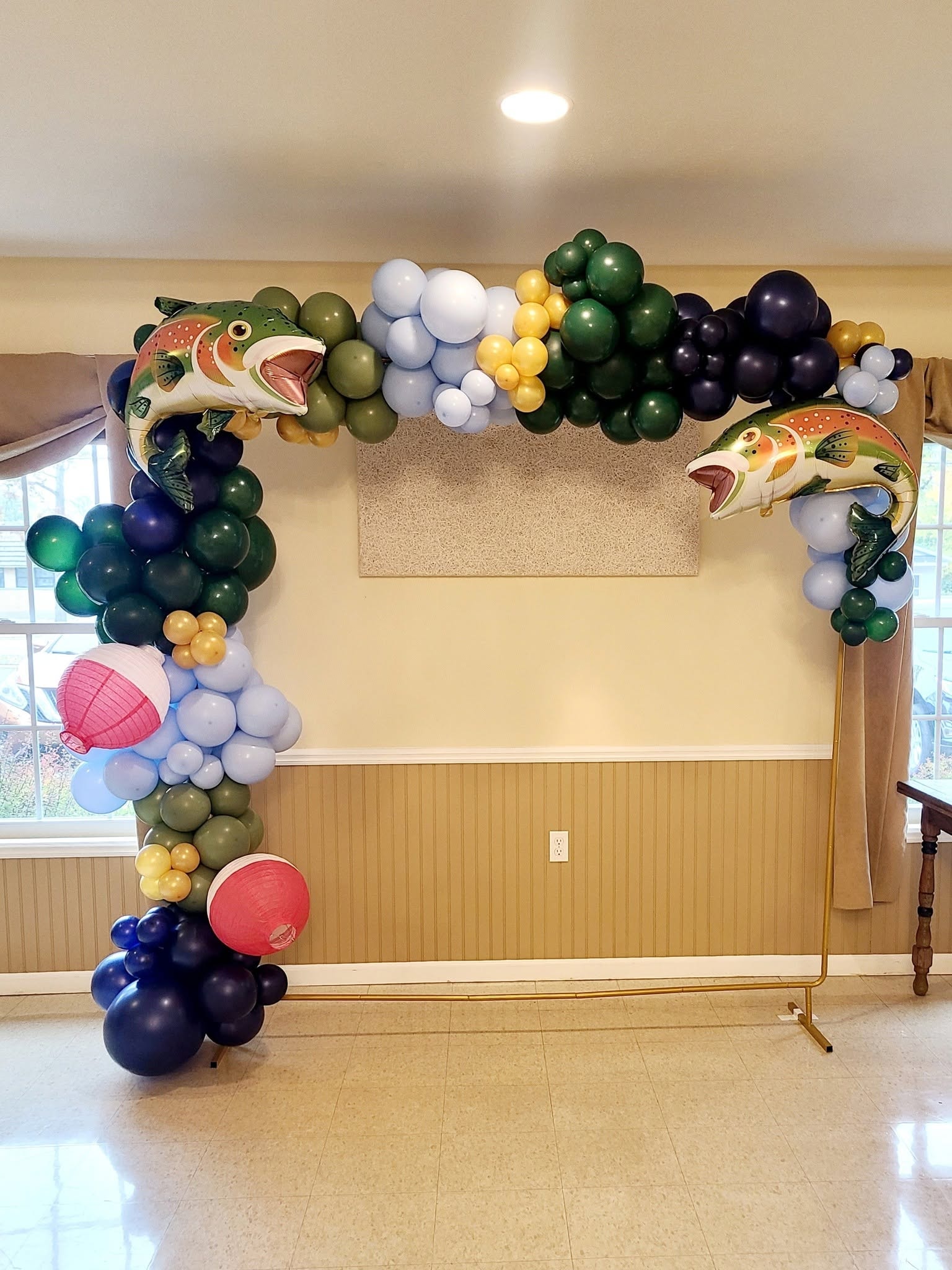 Fishing themed balloon arch with fish foils and bobbers