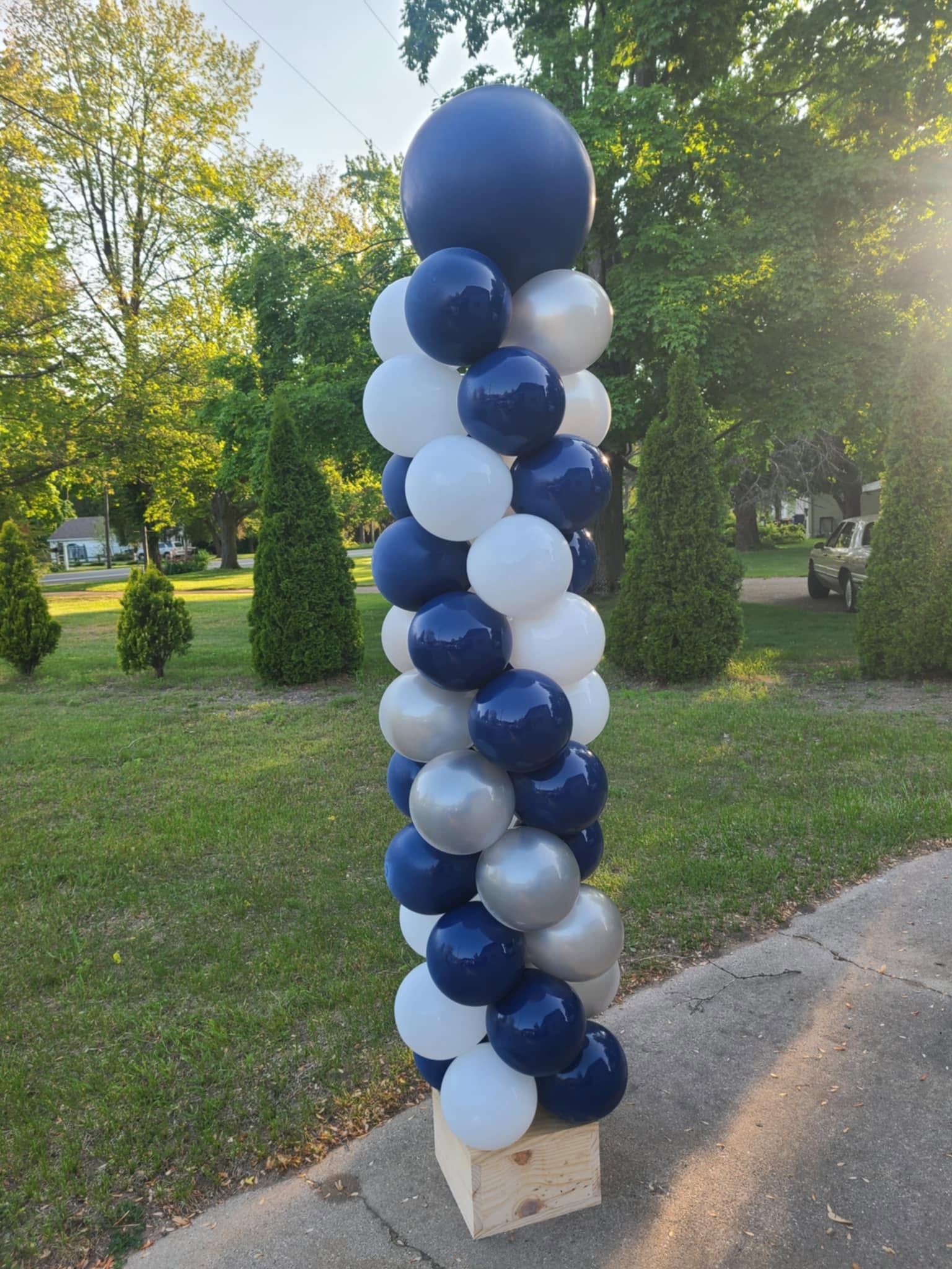 Navy white and silver large balloon column on wooden base