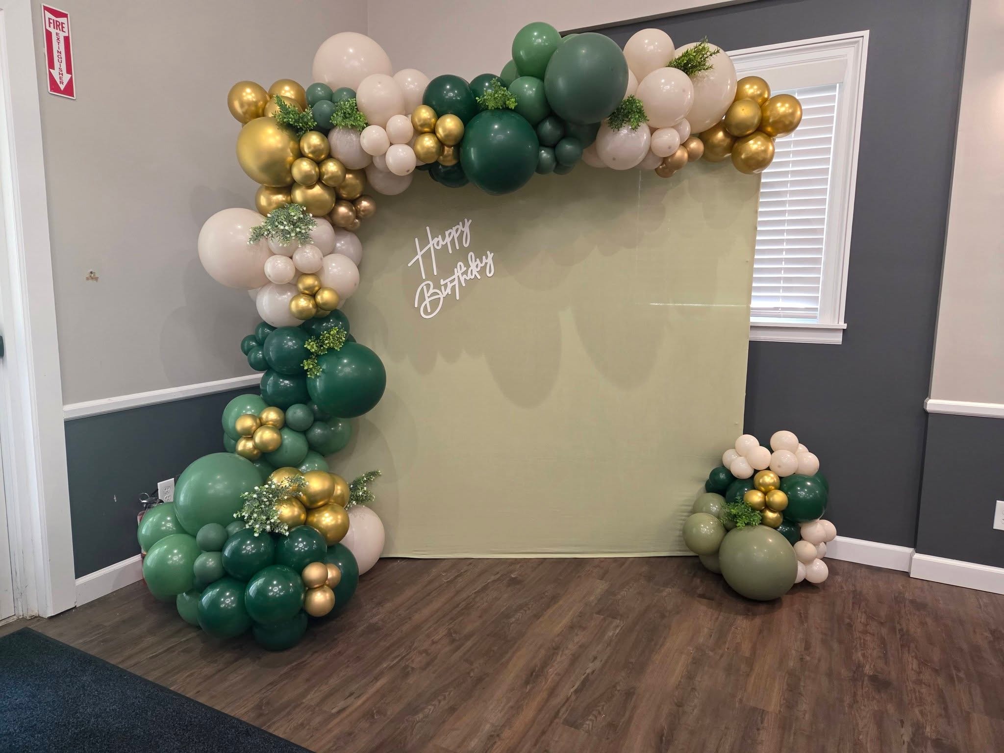 Green and gold birthday balloon garland