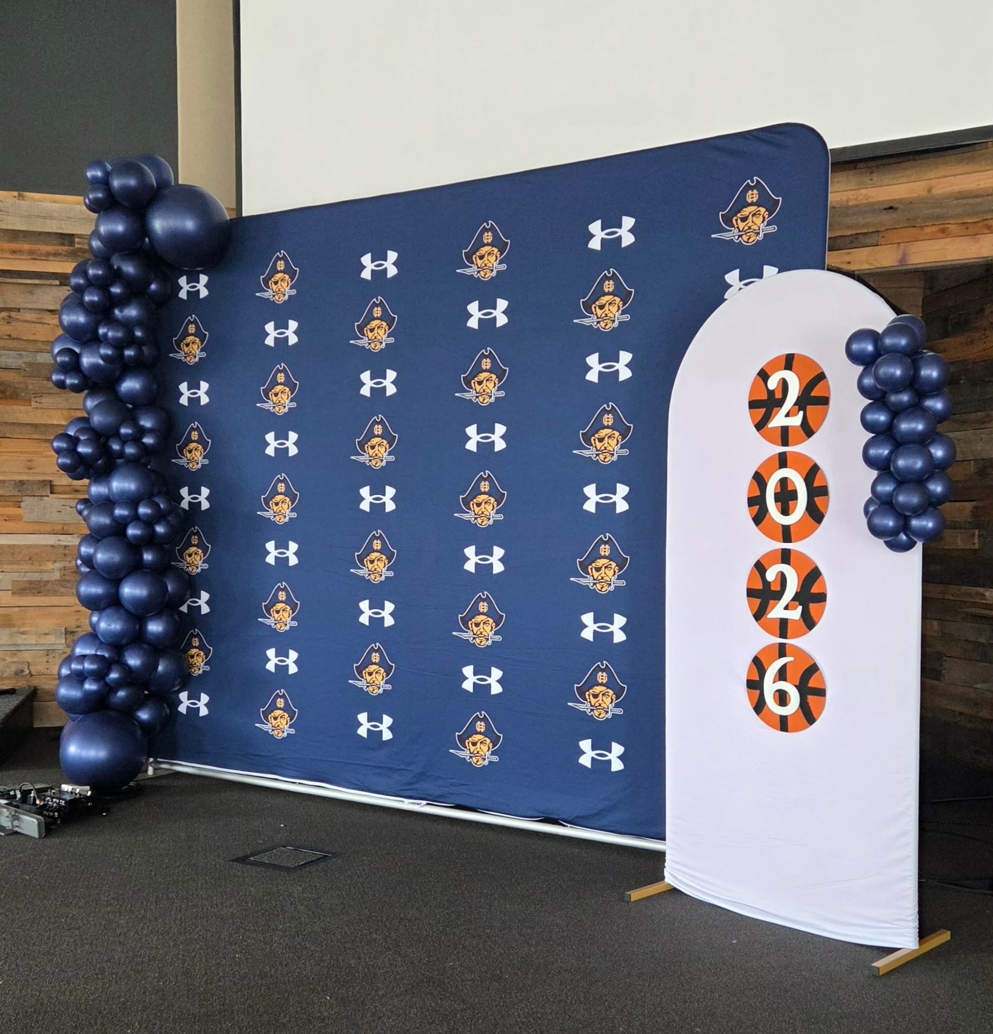 Navy blue graduation backdrop with balloon columns