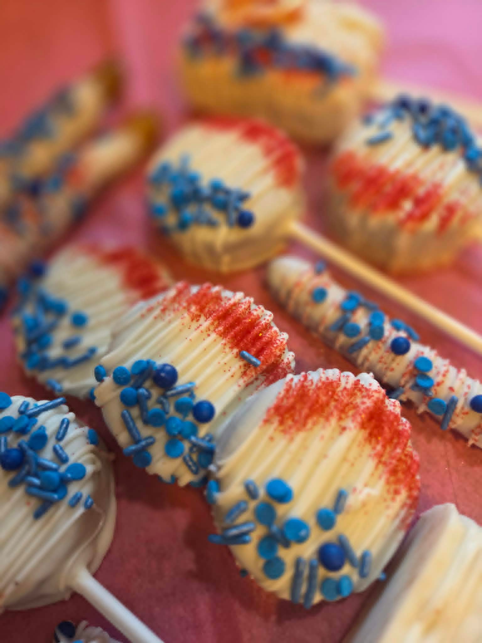 Red white and blue Oreo pops and treats arranged on a tray